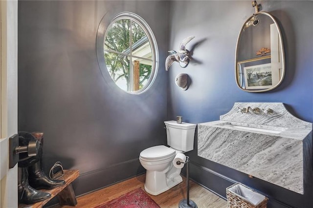 bathroom featuring hardwood / wood-style floors and toilet