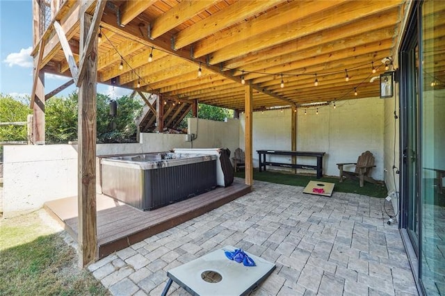 view of patio featuring a hot tub and a deck