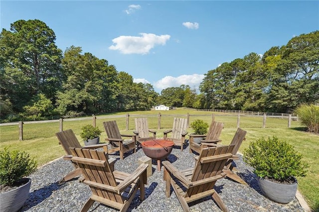 view of patio featuring a rural view and an outdoor fire pit