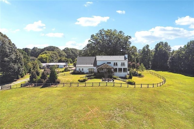 exterior space with a rural view and a yard