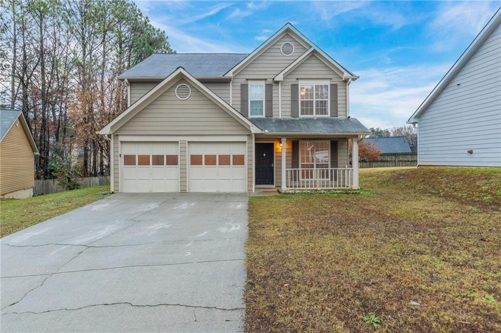 view of property with covered porch and a front yard