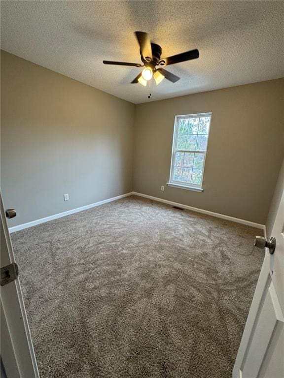 carpeted spare room featuring a textured ceiling