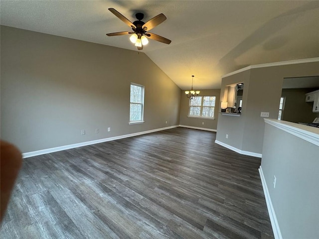 unfurnished living room with dark hardwood / wood-style flooring, ceiling fan with notable chandelier, and lofted ceiling