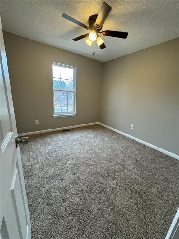 carpeted empty room featuring a textured ceiling and ceiling fan