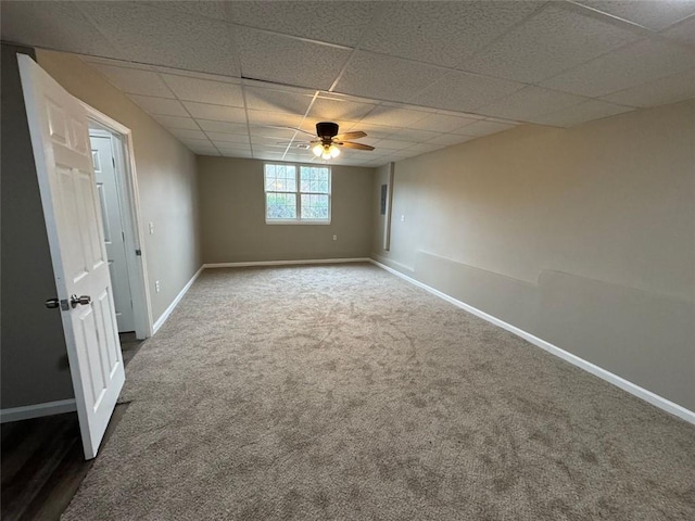 carpeted empty room with a paneled ceiling and ceiling fan