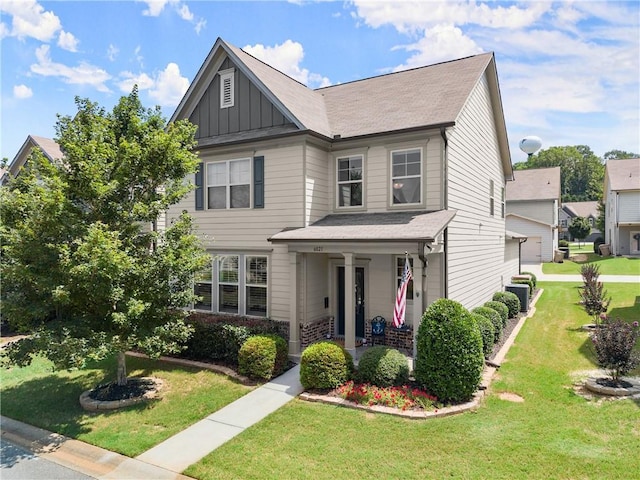 6021 Harbour Mist Dr, Flowery Branch, GA 30542 - view of front facade with board and batten siding, a porch, a front lawn, and a shingled roof
