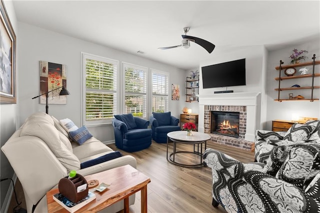 6021 Harbour Mist Dr, Flowery Branch, GA 30542 - living room with ceiling fan, light wood-style floors, and a fireplace