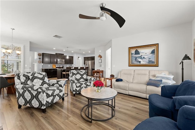 6021 Harbour Mist Dr, Flowery Branch, GA 30542 - living area featuring a chandelier, light wood-style flooring, ceiling fan, and recessed lighting