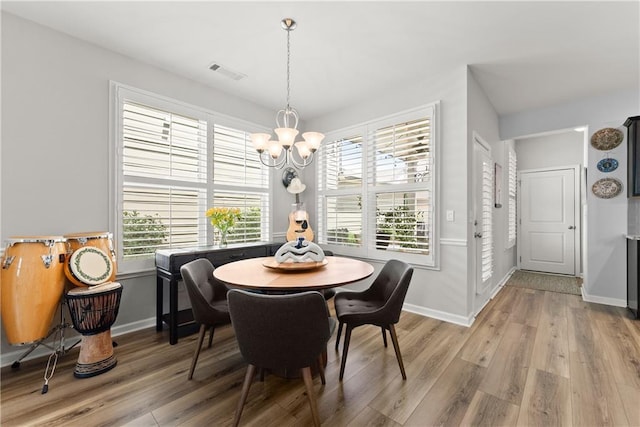 6021 Harbour Mist Dr, Flowery Branch, GA 30542 - dining area with a chandelier and light wood finished floors