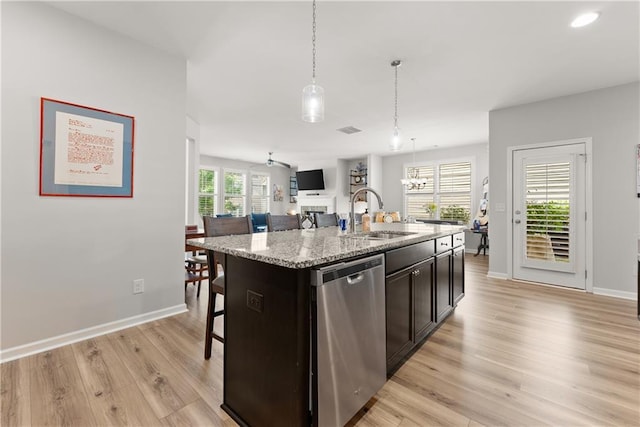 6021 Harbour Mist Dr, Flowery Branch, GA 30542 - kitchen with dishwasher, open floor plan, light wood-type flooring, decorative light fixtures, and a kitchen island with sink
