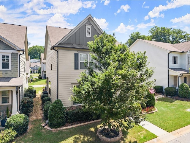 6021 Harbour Mist Dr, Flowery Branch, GA 30542 - view of front of property featuring board and batten siding, a front lawn, and a residential view