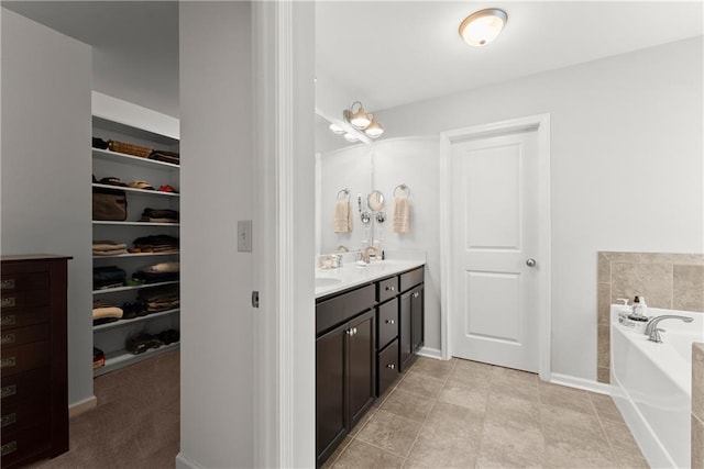 6021 Harbour Mist Dr, Flowery Branch, GA 30542 - full bath with double vanity, a garden tub, a walk in closet, and tile patterned floors