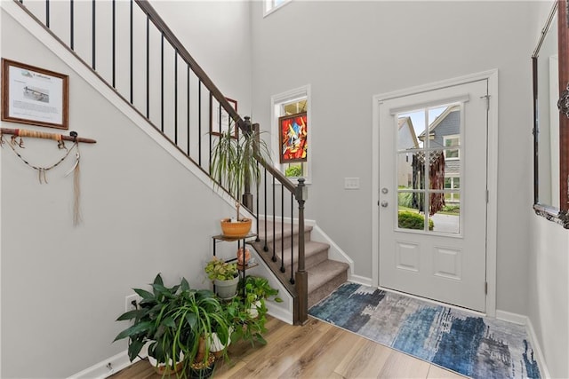 6021 Harbour Mist Dr, Flowery Branch, GA 30542 - entryway with healthy amount of natural light, wood finished floors, and stairway