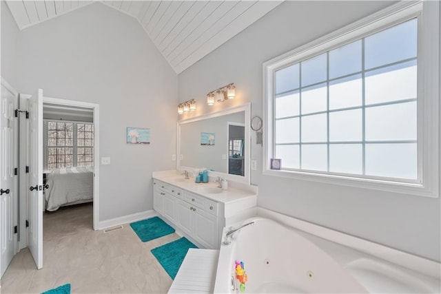 2995 Barimore, Dacula, GA 30019 - full bathroom featuring healthy amount of natural light, vaulted ceiling, a tub with jets, double vanity, and connected bathroom