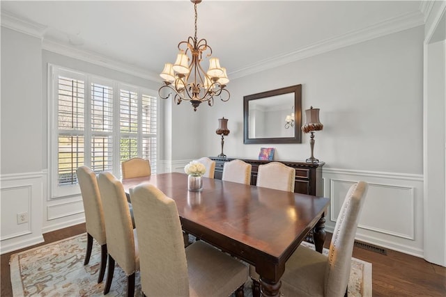 2995 Barimore, Dacula, GA 30019 - dining room featuring a chandelier, wood finished floors, ornamental molding, a decorative wall, and a wainscoted wall