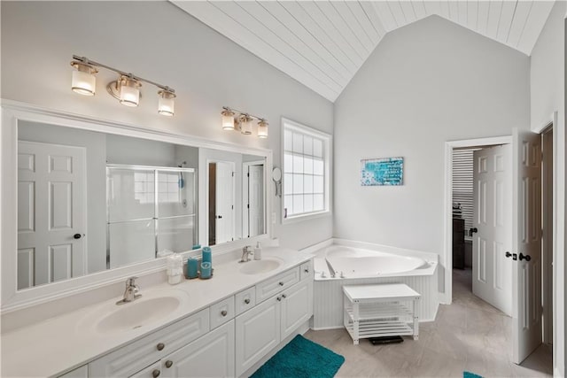 2995 Barimore, Dacula, GA 30019 - bathroom featuring lofted ceiling, healthy amount of natural light, a stall shower, double vanity, and a garden tub