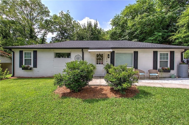 214 Iron St NW, Rome, GA 30165 - ranch-style home with a front yard, concrete block siding, and a shingled roof