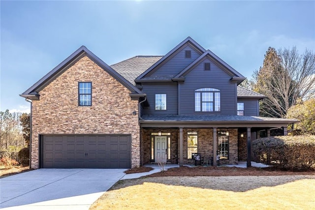 view of front of house with a garage, driveway, and a porch