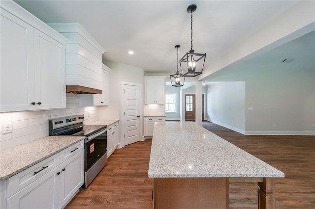 96 Lexie Ct, Rockmart, GA 30153 - kitchen featuring stainless steel range with electric cooktop, a center island, decorative backsplash, dark wood-style floors, and white cabinets