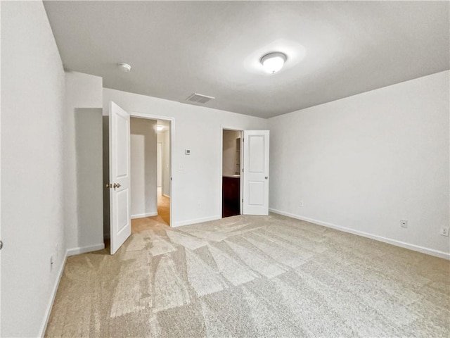 unfurnished bedroom featuring light colored carpet