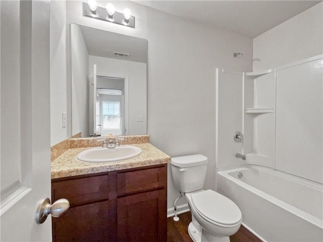 full bathroom featuring wood-type flooring, shower / bath combination, vanity, and toilet