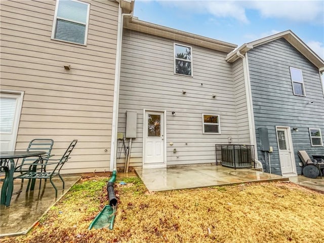 rear view of property with a patio and central AC unit