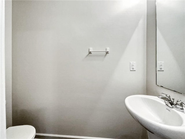 bathroom featuring sink and toilet