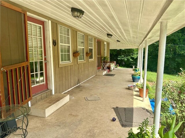 2115 Kings Rd, Dalton, GA 30720 - laundry area featuring wooden walls, washing machine and dryer, wood ceiling, and light carpet