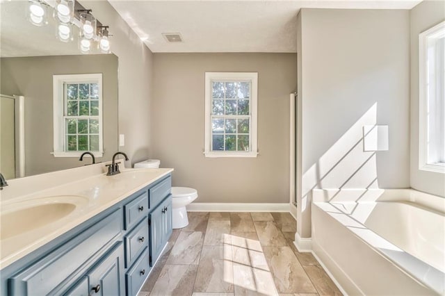 full bathroom with plus walk in shower, a healthy amount of sunlight, vanity, and toilet