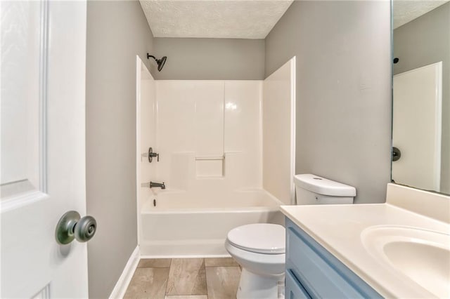 full bathroom with shower / bathing tub combination, vanity, toilet, and a textured ceiling