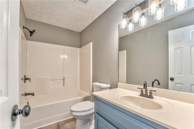 full bathroom featuring a textured ceiling, bathtub / shower combination, vanity, and toilet