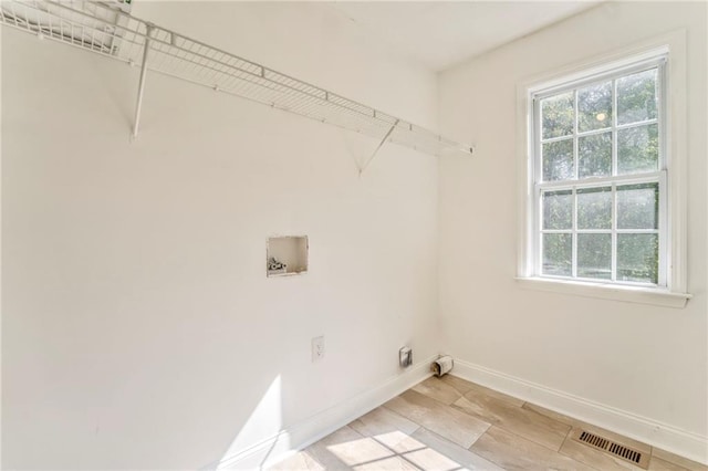 washroom with washer hookup, light hardwood / wood-style flooring, and electric dryer hookup