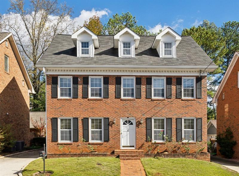 colonial inspired home featuring a front lawn