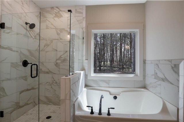 bathroom featuring separate shower and tub