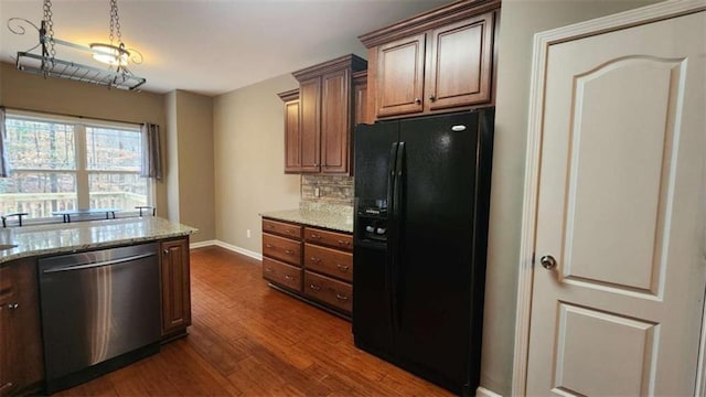 kitchen featuring tasteful backsplash, dishwasher, light stone countertops, dark wood-type flooring, and black refrigerator with ice dispenser