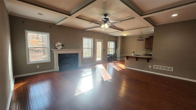 unfurnished living room featuring ceiling fan, coffered ceiling, dark hardwood / wood-style flooring, and beam ceiling