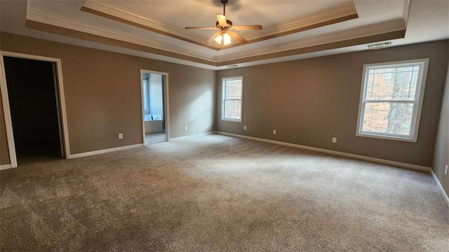 unfurnished room with crown molding, carpet, ceiling fan, and a tray ceiling
