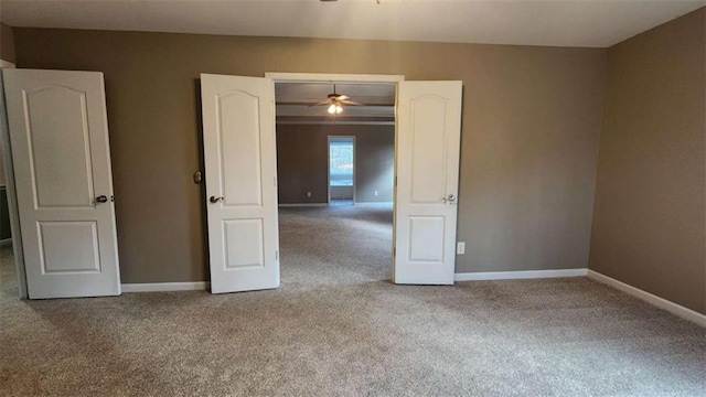 unfurnished room with ceiling fan and carpet flooring