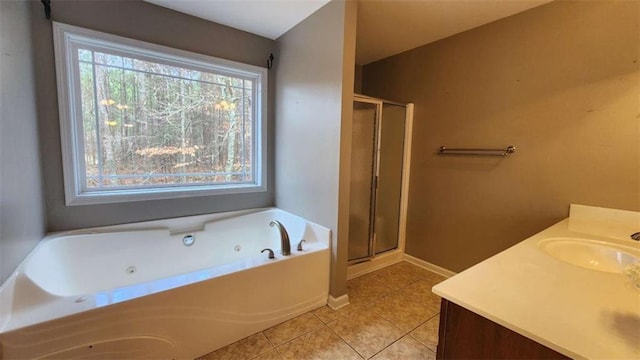 bathroom with independent shower and bath, vanity, and tile patterned floors