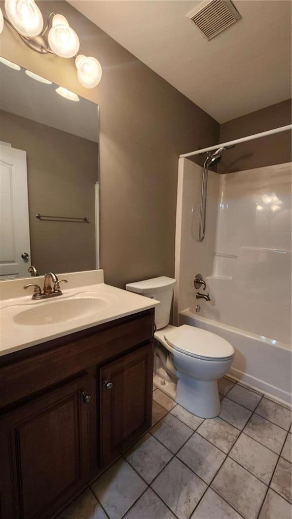 full bathroom with vanity, toilet, shower / bath combination, and tile patterned flooring