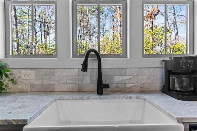 details featuring backsplash and a sink