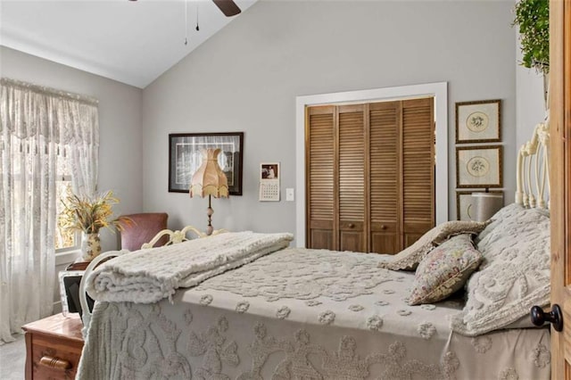 bedroom featuring lofted ceiling, a ceiling fan, and a closet