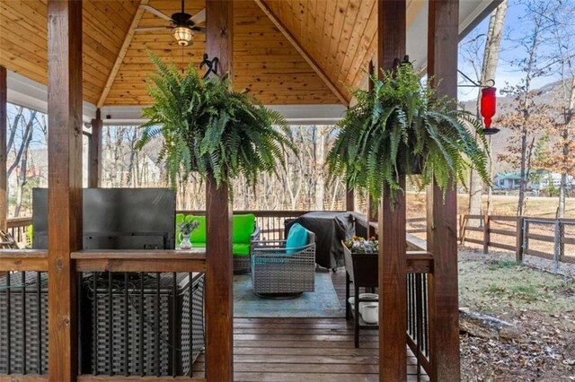 wooden deck featuring a gazebo, an outdoor hangout area, a grill, and fence