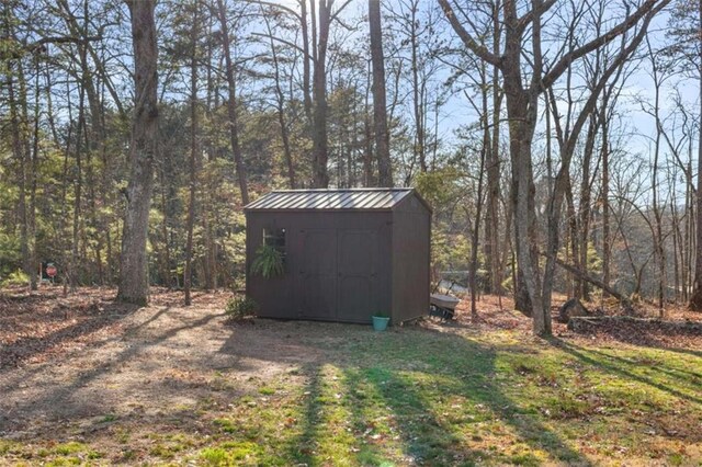 view of shed with a forest view