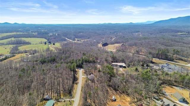 aerial view featuring a view of trees and a mountain view