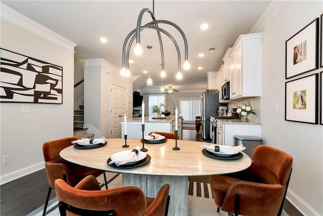 dining space with ornamental molding and dark hardwood / wood-style floors