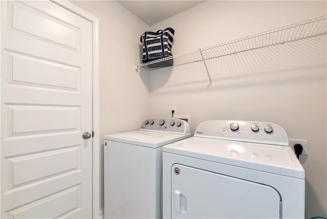 laundry area featuring washing machine and clothes dryer