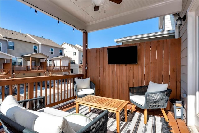 wooden terrace featuring an outdoor living space and ceiling fan