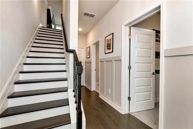 stairway with hardwood / wood-style floors