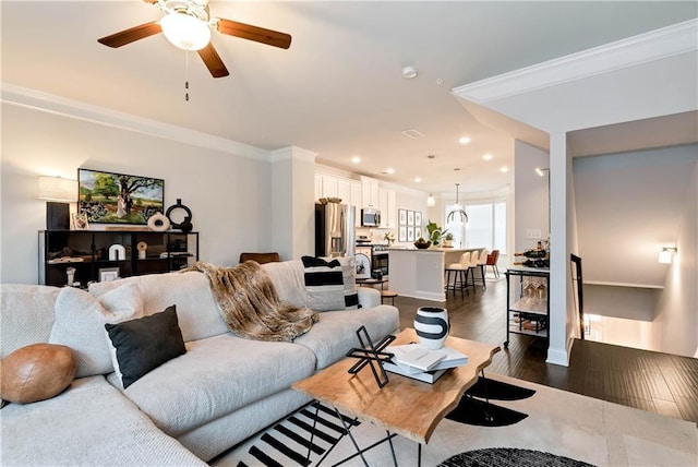 living room featuring crown molding, dark hardwood / wood-style floors, and ceiling fan